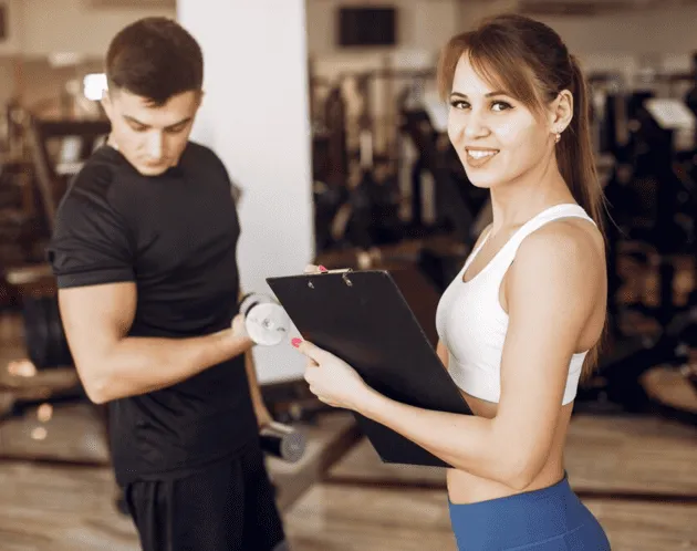  Company Setup Emirates - Two people in a gym, one holding a dumbbell, the other a clipboard. 