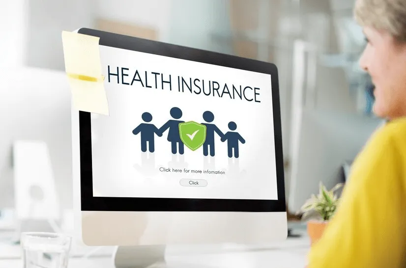 creating a company in dubai-Computer screen displaying 'HEALTH INSURANCE' with a graphic of figures and a protective shield.